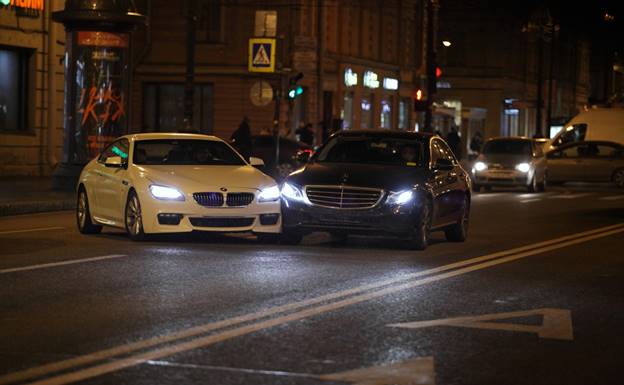 A white car with its headlights on

AI-generated content may be incorrect.